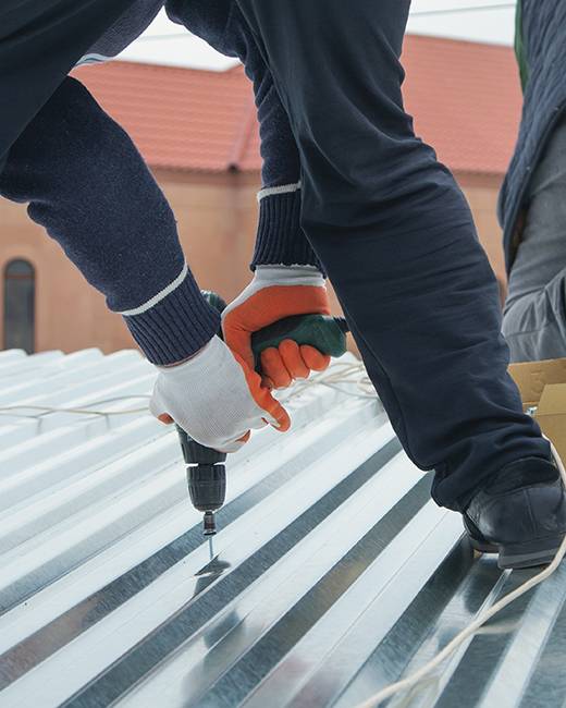 screwing down metal roof panel